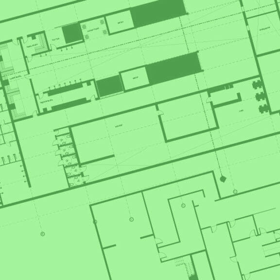 In this image: Green blueprints of a building.