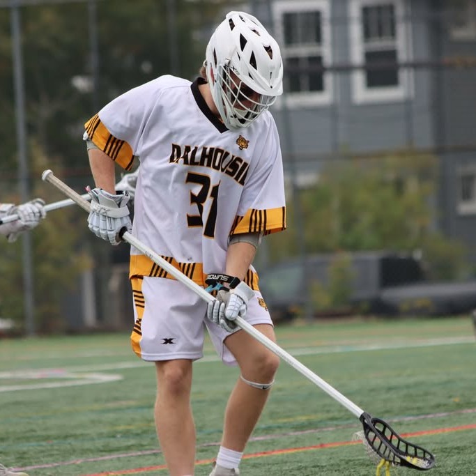 Members of the Dalhousie Tigers men's lacrosse team warm up before a game against St. Francis Xavier University at Wickwire Field in Halifax, on Oct. 18, 2026. (Sylvia Daigle Garcia/The Dalhousie Gazette)