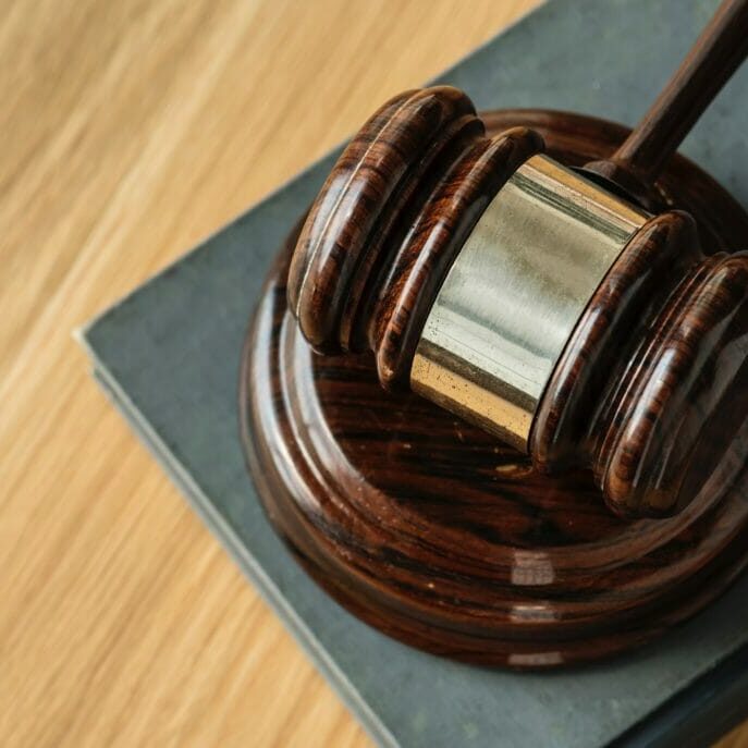 A gavel resting on a sound block.