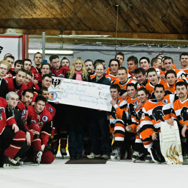 Last year's Bighorns (left) and Trojans put aside their differences in support of the IWK. (Photo by Chris Parent)