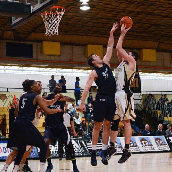 Devon Stedman (15) puts up a contested shot in the paint. (Photo by Kit Moran)