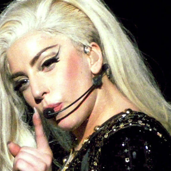 In this image: headshot of Lady Gaga performing.