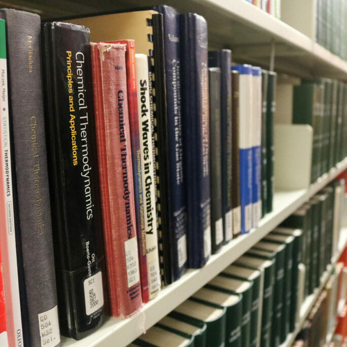 In this image: the spines of books on a Killam Library shelf.